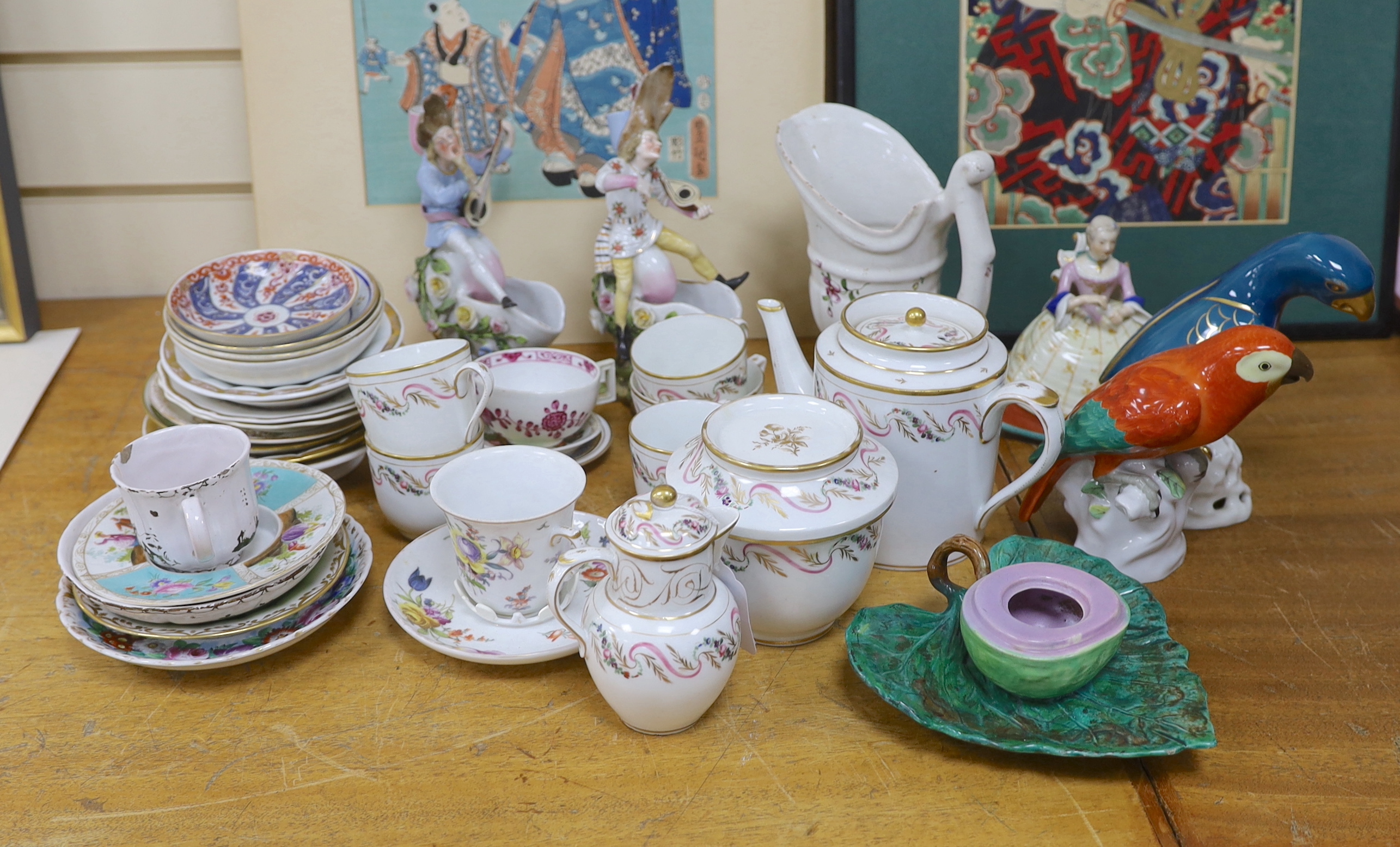 Assorted Continental ceramics, mainly 19th century, including two figures of parrots, two candle holders in the form of musicians, a teapot, jugs, various cups and sauces, etc.